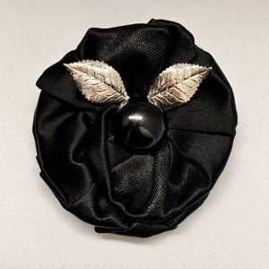 Black satin rosette brooch